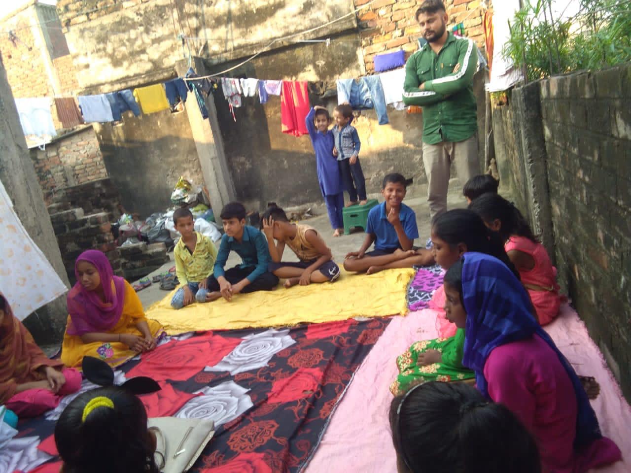 Syed Shahnawaz (standing in green shirt), facilitating a General Body Meeting